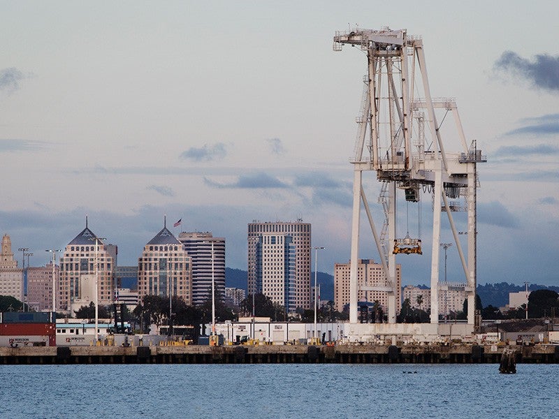 A crane looms over the Port of Oakland.