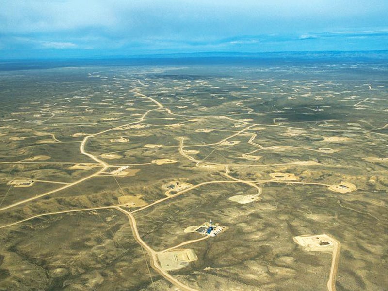 An aerial view of the Upper Green River Valley of Wyoming shows the vast network of roads and well pads that make up a portion of the Jonah natural gas field.