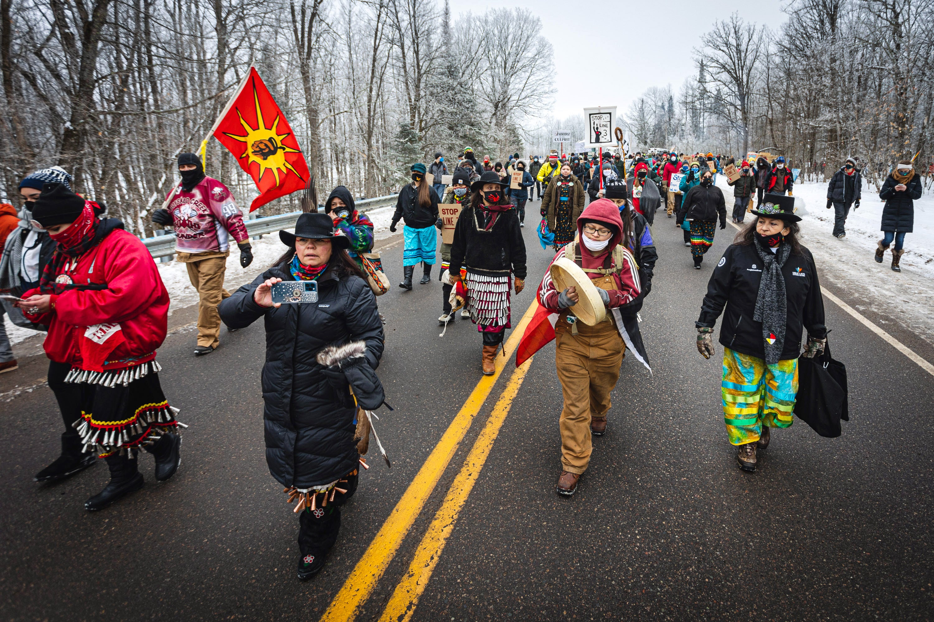 Native women lead hundreds of marchers to a spot near where the Line 3 pipeline will cross under the Mississippi River during a protest on Jan. 9, 2021.