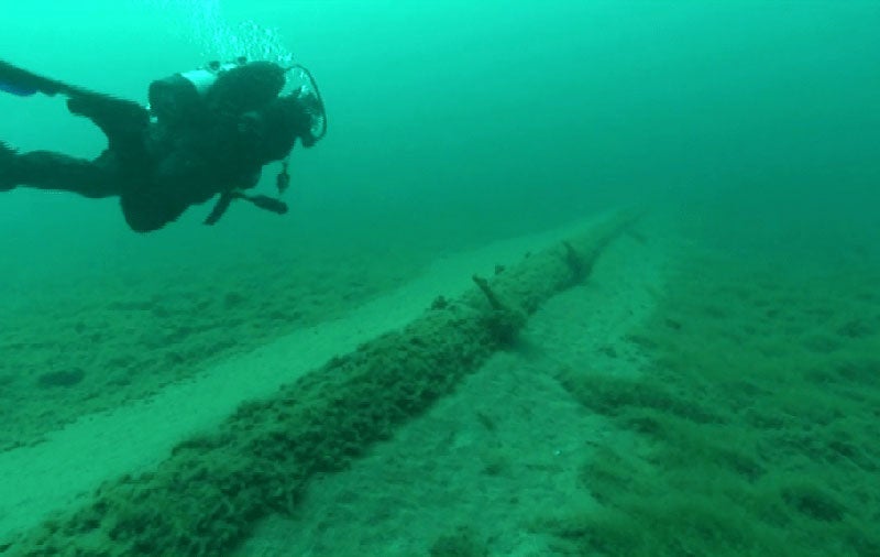 A diver examines the Line 5 Pipeline. The old pipeline has structural problems.