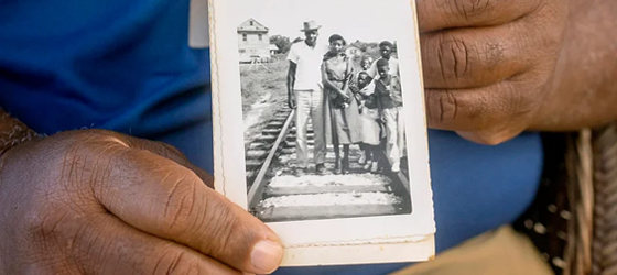 Ironton resident Wilkie DeClouet, the husband of Andrea, holds a family photograph. (L. Kasimu Harris for Earthjustice)