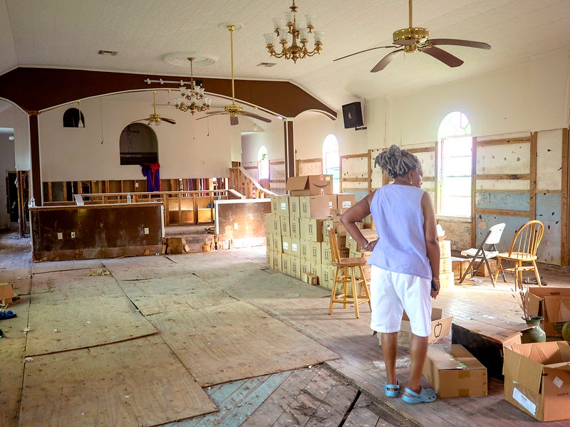 Andrea DeClouet looks over the sanctuary of Saint Paul Missionary Baptist Church in Ironton, which was damaged by Hurricane Ida in 2021.