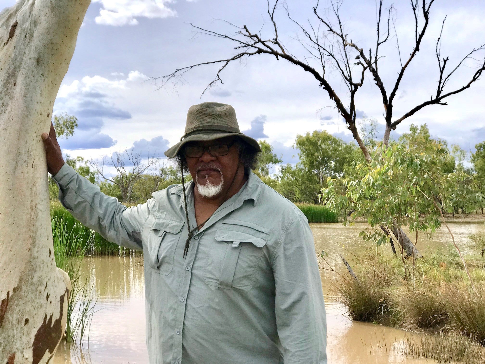 Wangan and Jagalingou cultural leader Adrian Burragubba visits Doongmabulla Springs, his people's most sacred site. The Wangan and Jagalingou are fighting a proposed coal mine that would likely destroy the springs.