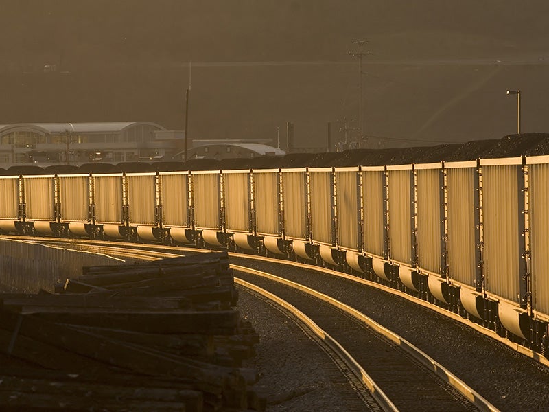 Loaded coal hoppers at sunset.