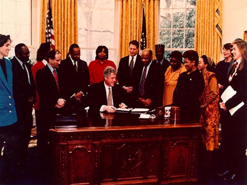 President Clinton signs the Executive Order in the Oval Office (February 11, 1994).