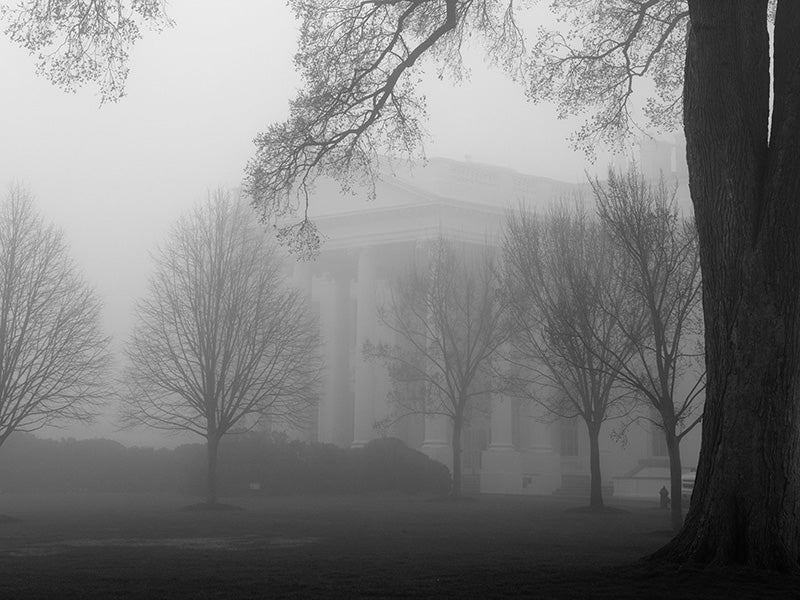 The North Portico of the White House is seen through the fog, April 1, 2013.