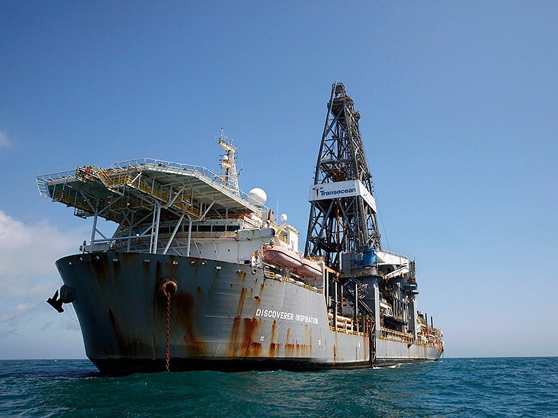 An oil drilling ship sits anchored in the Gulf of Mexico. The Inflation Reduction Act reinstates a sale of 80 million offshore acres in the Gulf of Mexico to oil and gas drilling. 