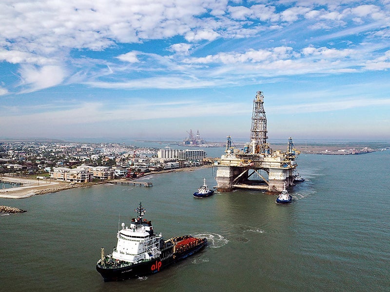Tugboats tow the semi-submersible drilling platform Noble Danny Adkins through the Port Aransas Channel into the Gulf of Mexico in 2020 in Port Aransas, Texas. Tugboats tow the semi-submersible drilling platform Noble Danny Adkins through the Port Aransas Channel into the Gulf of Mexico in 2020 in Port Aransas, Texas.