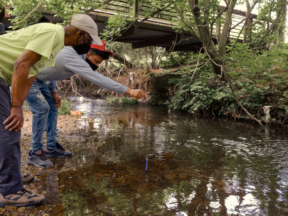 Dennis Chestnut teaches his grandson, Horus Plaza, how to test the water quality of the Watts Branch of the Anacostia River in Marvin Gaye Park in Washington, D.C. in May 2021. Dennis Chestnut teaches his grandson, Horus Plaza, how to test the water quality of the Watts Branch of the Anacostia River in Marvin Gaye Park in Washington, D.C. in May 2021.
