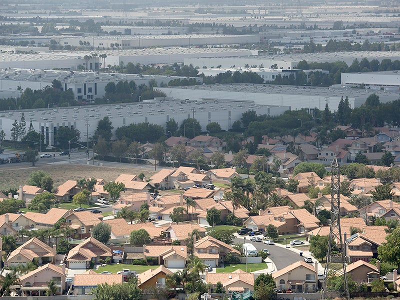This photo from 2015 shows a vast industrial area that includes numerous logistics facilities near homes in the Rancho Cucamonga and Fontana area of California.