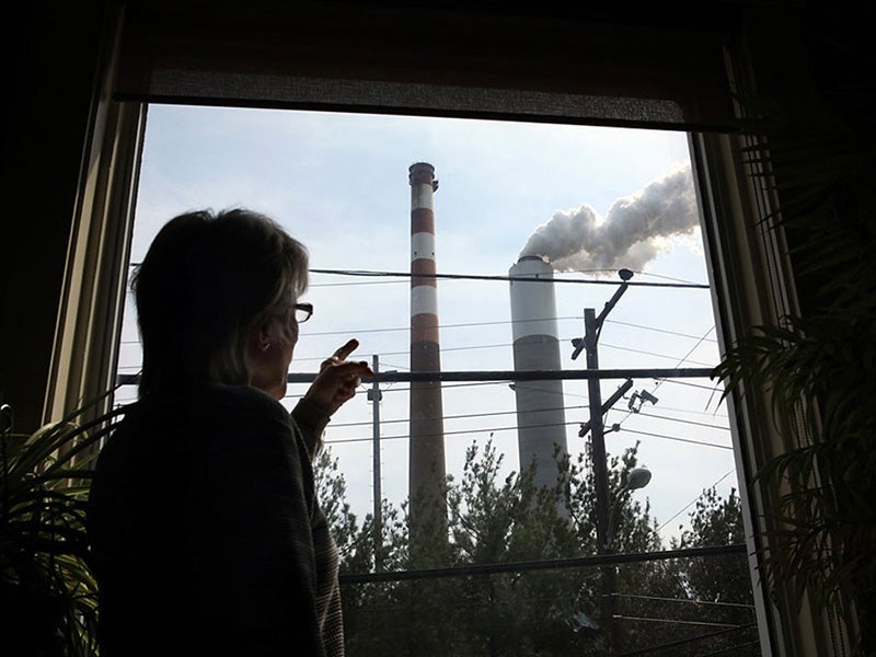 Marti Blake watches the Cheswick Generating Station from her home in Springdale, PA.
