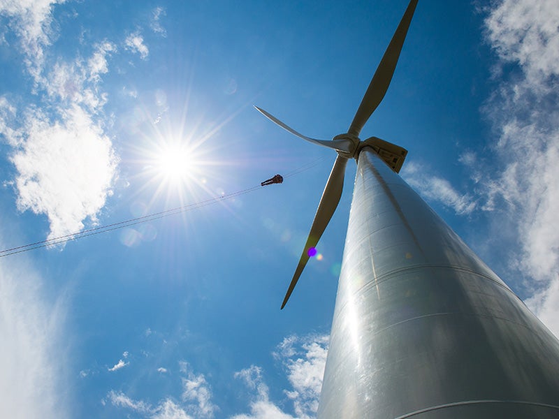 A technician repels down the blades of a wind turbine in Colorado during an inspection. A technician repels down the blades of a wind turbine in Colorado during an inspection.