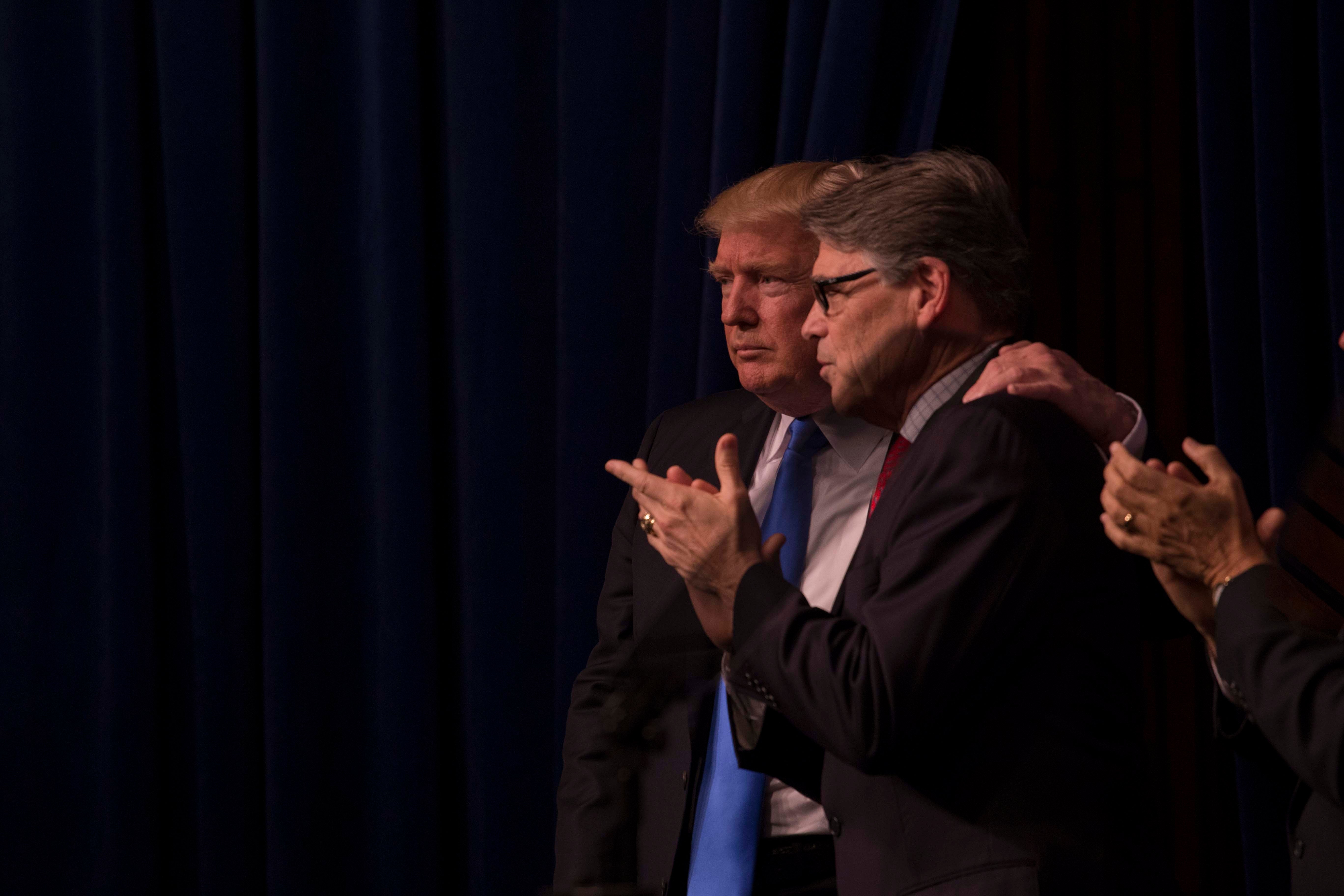 President Donald Trump and Secretary of Energy Rick Perry share a moment.