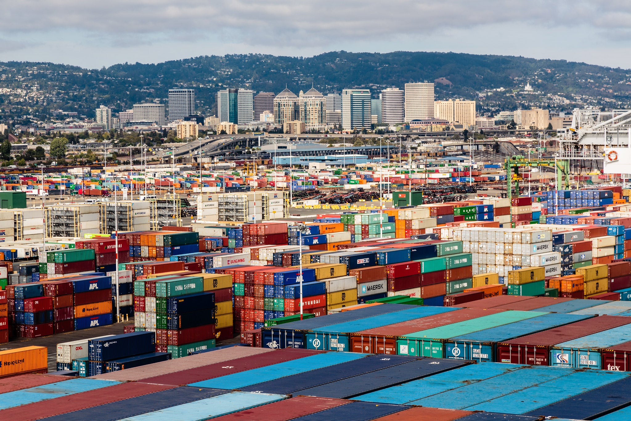 Shipping containers pile high at the Port of Oakland.