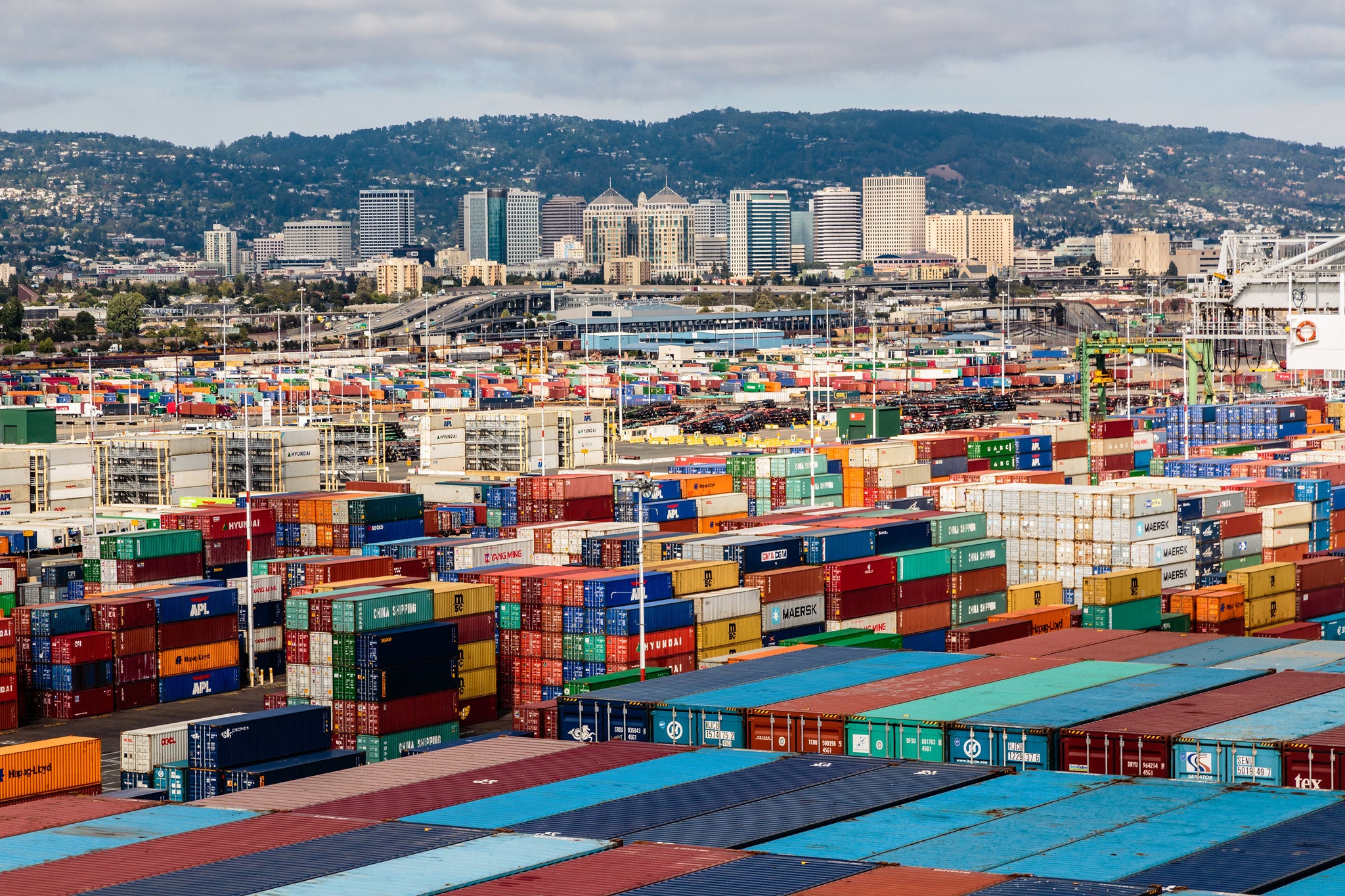 Shipping containers pile high at the Port of Oakland. Shipping containers pile high at the Port of Oakland.