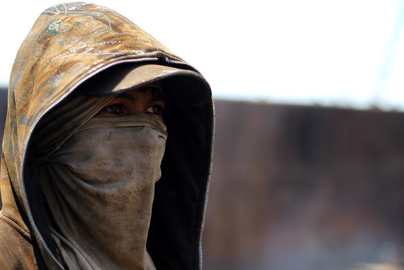 A shipbreaker in Jakarta wears a makeshift face mask. Jakarta has some of the most polluted air of any capital city.