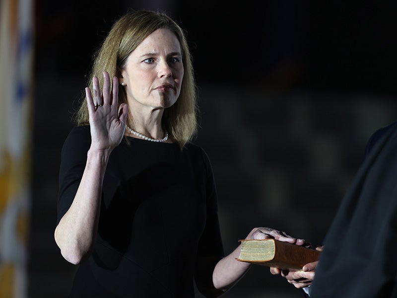 Justice Amy Coney Barrett is sworn in by Supreme Court Associate Justice Clarence Thomas on the South Lawn of the White House, Oct. 26, 2020.
