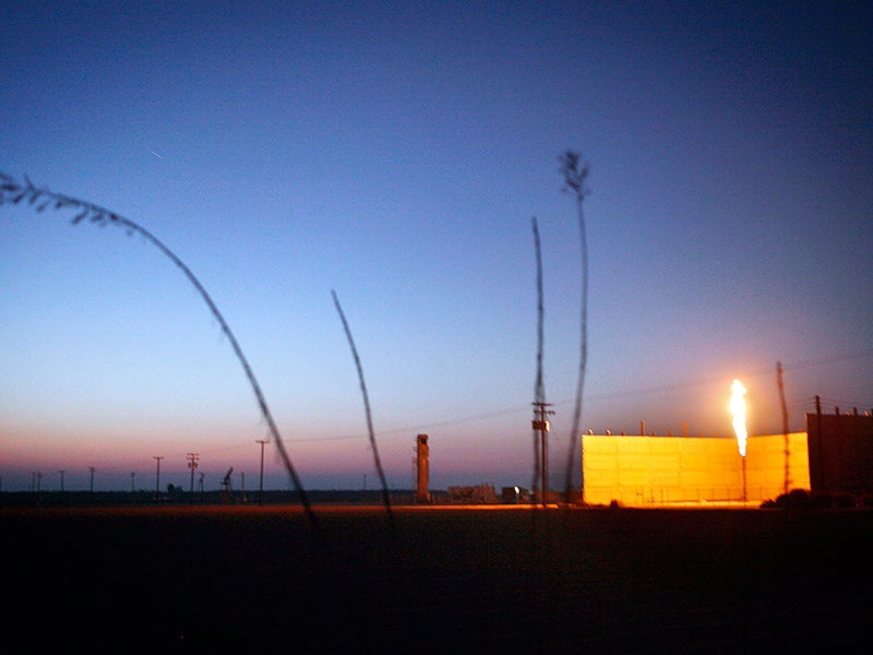 As the sun sets on another California day, a flare burns in an oil field near Bakersfield, CA. As the sun sets on another California day, a flare burns in an oil field near Bakersfield, CA.