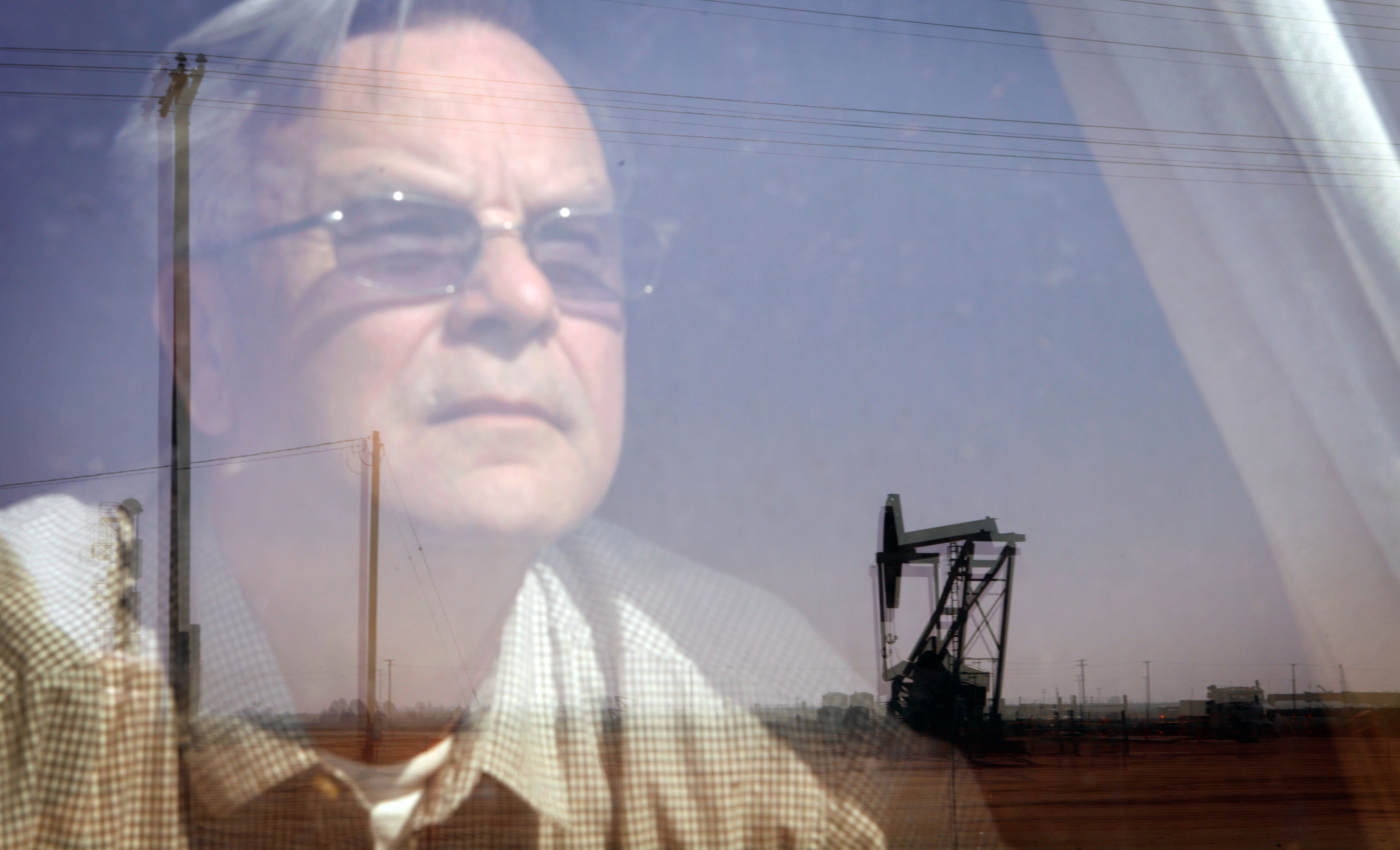 Kern County resident Walt Desatoff gazes at an oil derrick. Kern County resident Walt Desatoff gazes at an oil derrick.