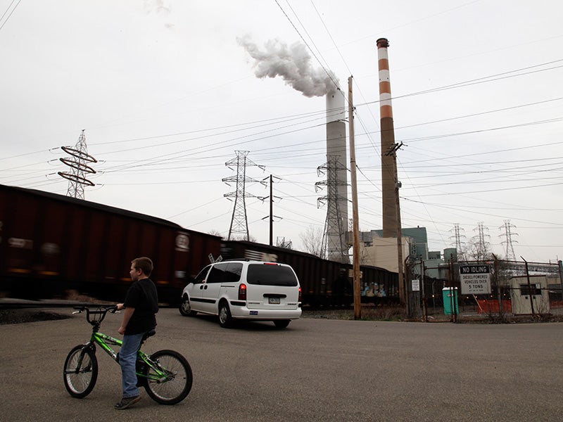 A child plays near the Cheswick coal-fired power plant in Pennsylvania. Burning coal is a major cause of climate change and releases toxic pollution that threatens our air and water.