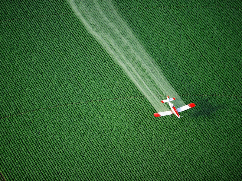 A cropduster sprays agricultural fields. 