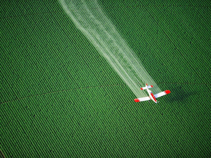 A cropduster sprays agricultural fields. A cropduster sprays agricultural fields.