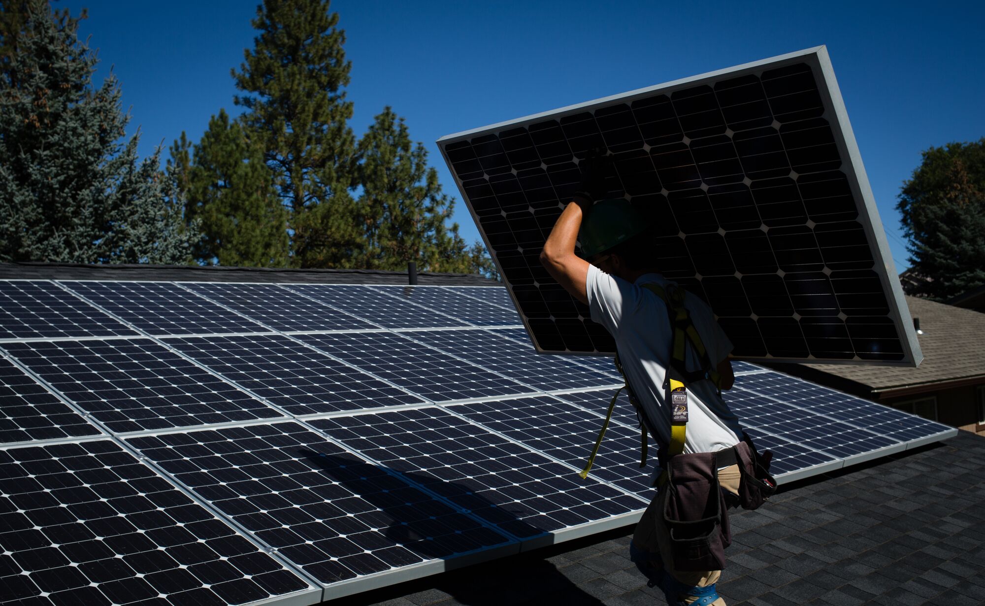 Workers for EcoDepot Inc. install solar panels on a roof in Spokane, Washington. Workers for EcoDepot Inc. install solar panels on a roof in Spokane, Washington.
