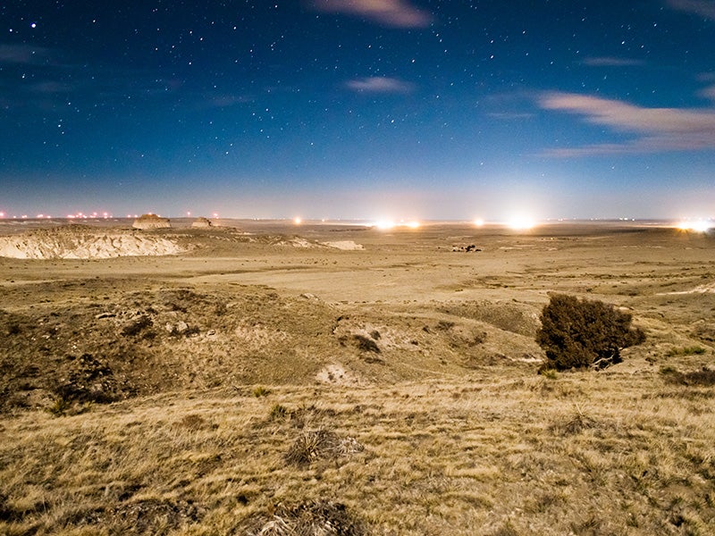 Drill sites light up the evening sky in Pawnee National Grasslands, Colorado. Drill sites light up the evening sky in Pawnee National Grasslands, Colorado.