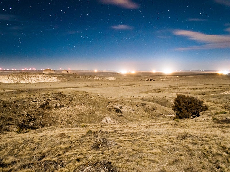 Drill sites light up the evening sky in Pawnee National Grasslands, Colorado.