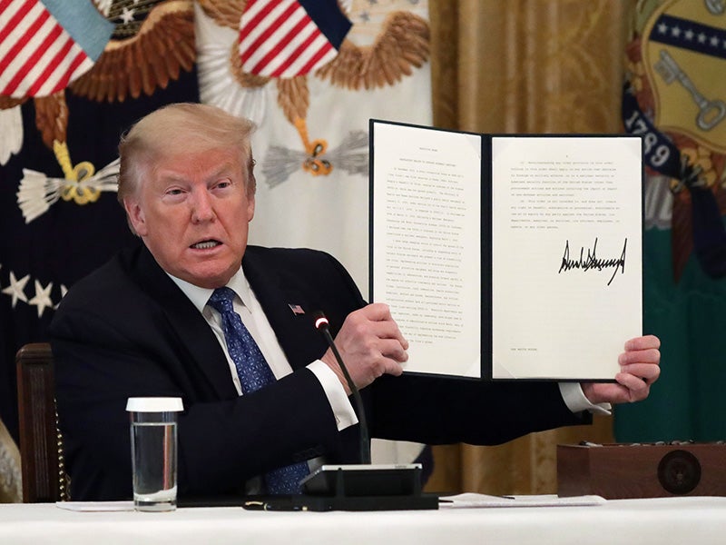 President Donald Trump displays the executive order signed on May 19, 2020, requiring agencies to search for public protections to suspend in the middle of the global respiratory pandemic. President Donald Trump displays the executive order signed on May 19, 2020, requiring agencies to search for public protections to suspend in the middle of the global respiratory pandemic.