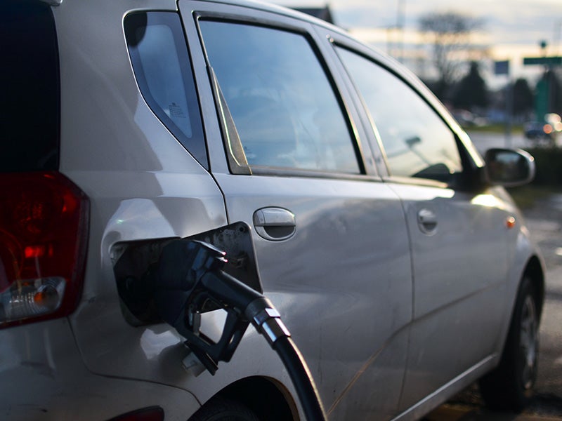 Filling up a car's tank at a gas station. Filling up a car's tank at a gas station.