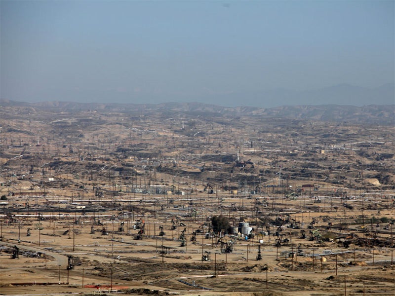 Hazy air covers an active drilling field in California. Hazy air covers an active drilling field in California.
