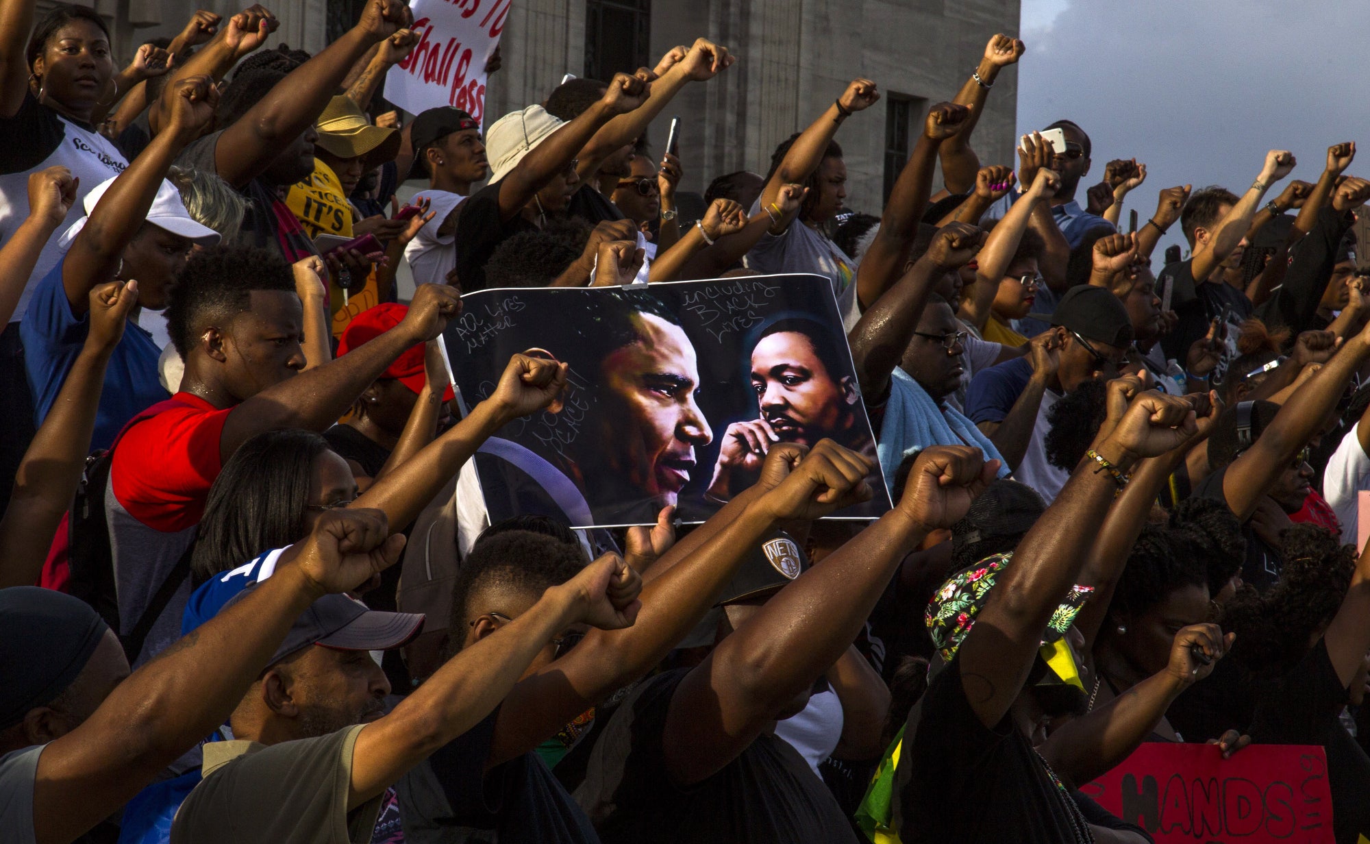 Demonstrators gather after marching at the Louisiana Capitol to protest the shooting of Alton Sterling on July 9, 2016 in Baton Rouge, Louisiana.