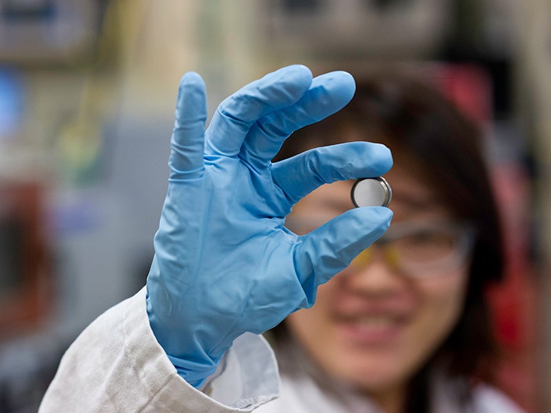 A scientist holds a lithium Ion battery made in the materials lab at the Solar Energy Research Facility at the National Renewable Energy Laboratory in Golden, CO.