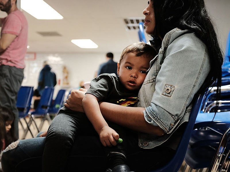 A woman who identified herself as Jennifer sits with her son Jaydan at the Catholic Charities Humanitarian Respite Center after crossing the U.S.-Mexico border in McAllen, Texas.