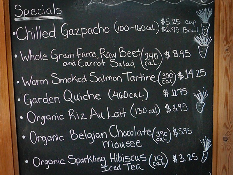 Calories are listed on a chalkboard menu at a restaurant. Calories are listed on a chalkboard menu at a restaurant.