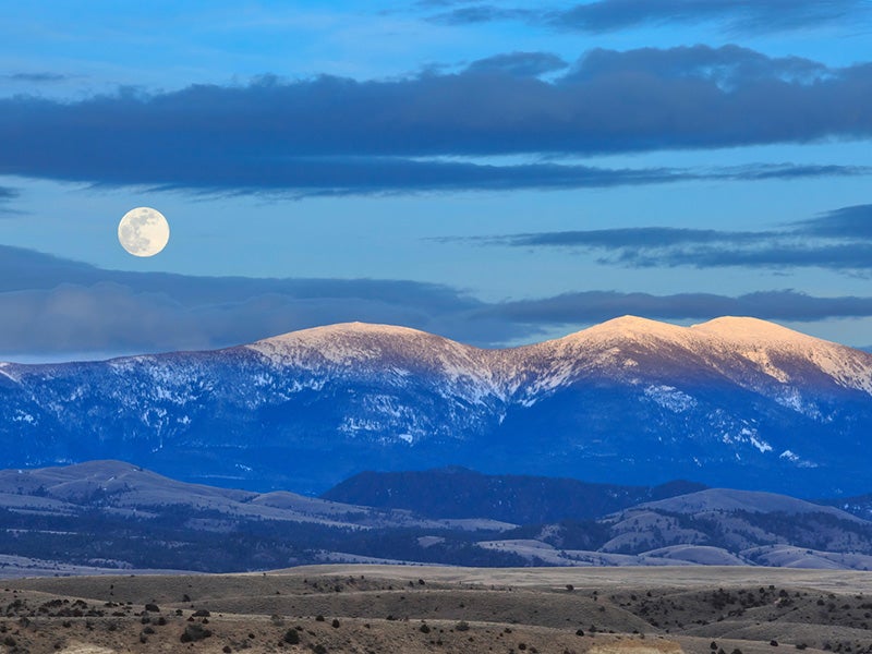  A full moon is seen above Mount Baldy in the Big Belt Mountains near Townsend, Montana, April 2019. Nearby land was recently protected by a federal judge ruling; however, the Big Belt Mountains are still at risk.