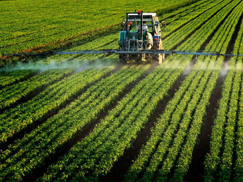 Pesticides being applied to a farm field. Pesticides being applied to a farm field.