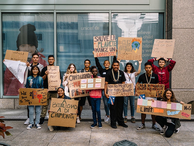 Youth petitioners display their signs before marching in the Sept. 20 Global Climate Strike in New York City.