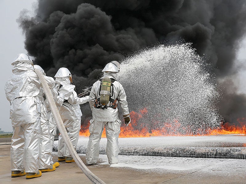 Marines use firefighting foam during a live fire training exercise aboard Marine Corps Air Station Cherry Point in North Carolina in August 2013. PFAS chemicals in firefighting foam have contaminated hundreds of military bases across the country. 