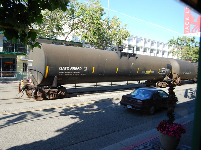 Rail traffic travels through the City of Oakland, near Jack London Square.