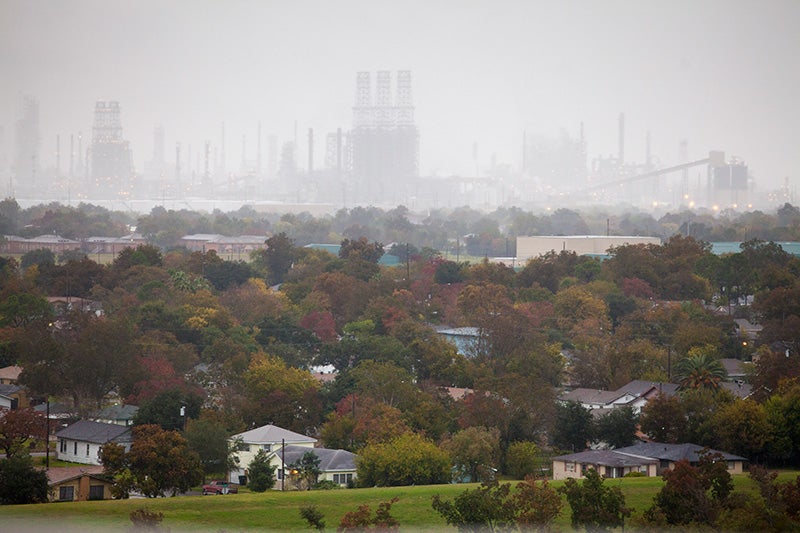 An oil refinery looms over the west side of Port Arthur, TX.