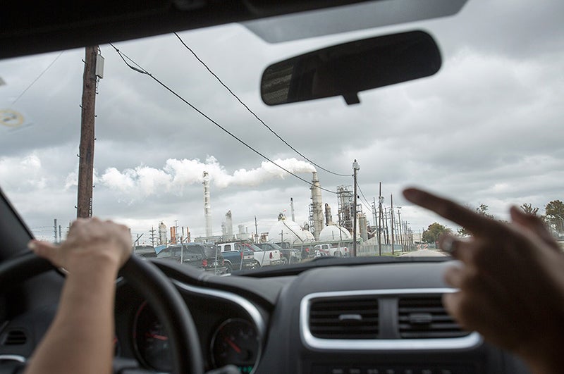 Photo of a polluting oil refinery through the windshield a car leading a "toxic tour" 