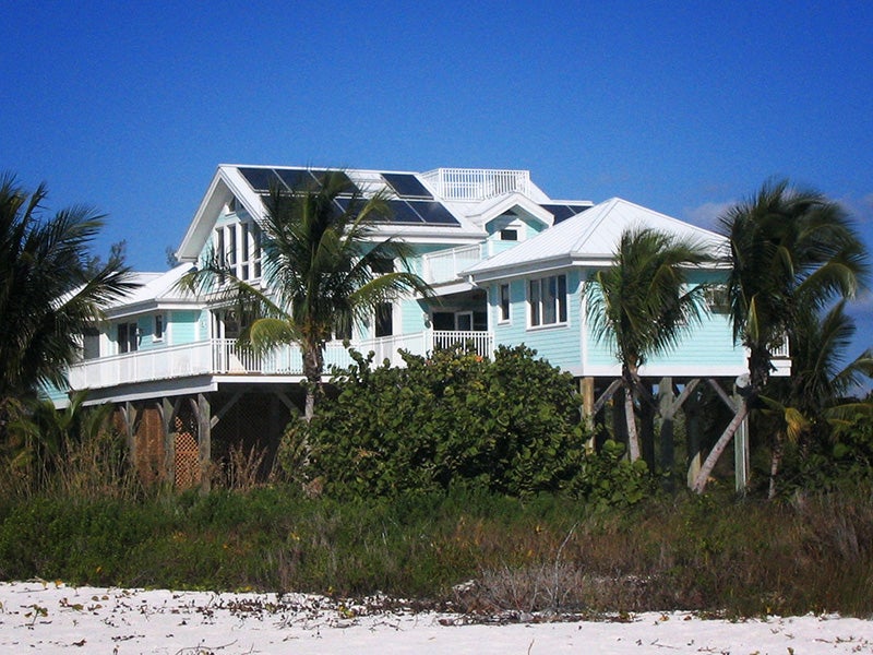 Rooftop solar panels on a beach house in southern Florida. Rooftop solar panels on a beach house in southern Florida.