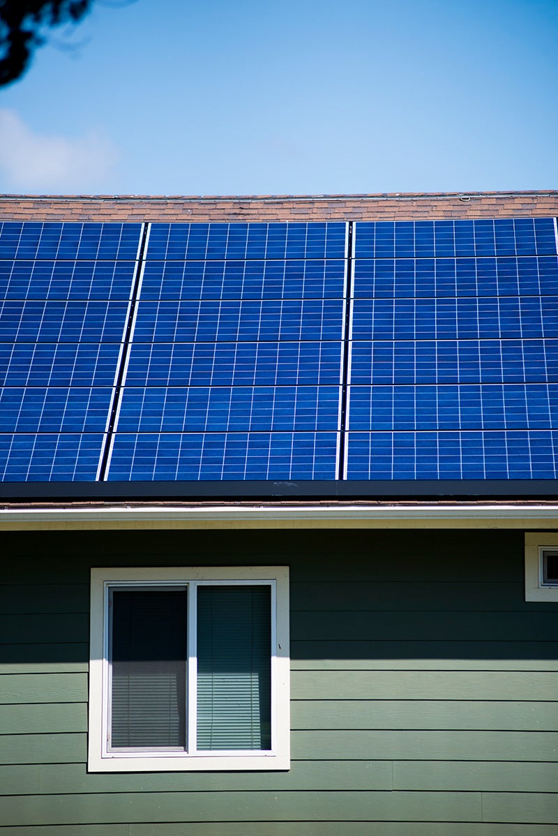Rooftop solar panels on homes in Salt Lake, Oahu, Hawaii.
