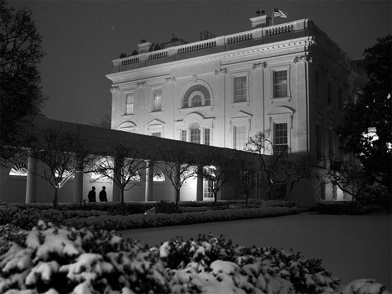 Snow blankets the Rose Garden at the White House.