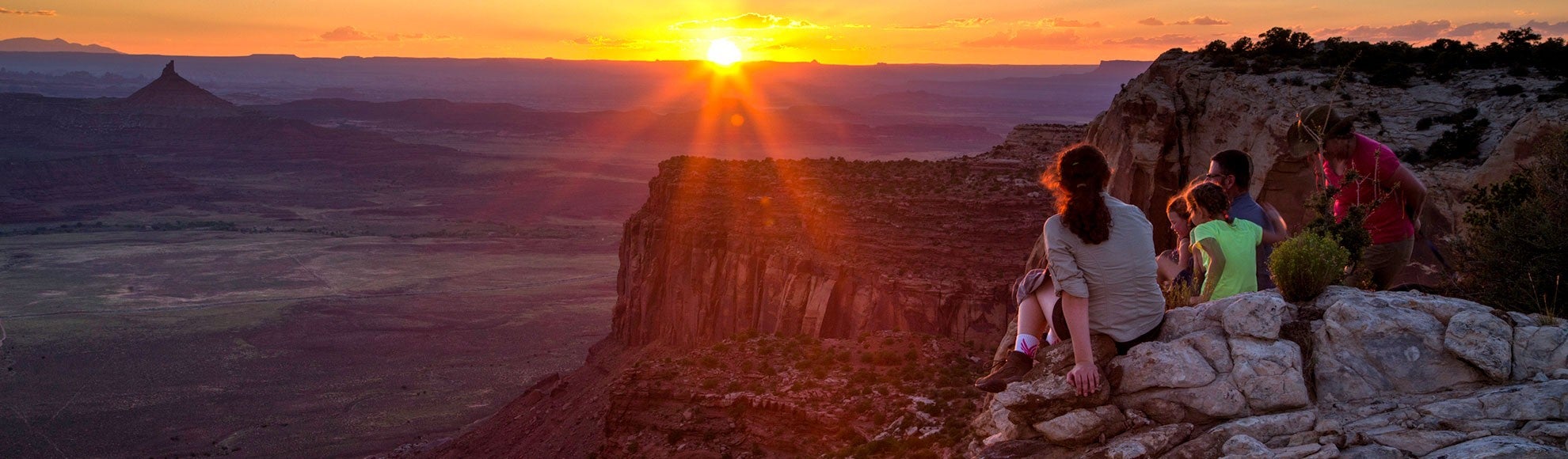 Visitors watch the sun set at Bears Ears National Monument.