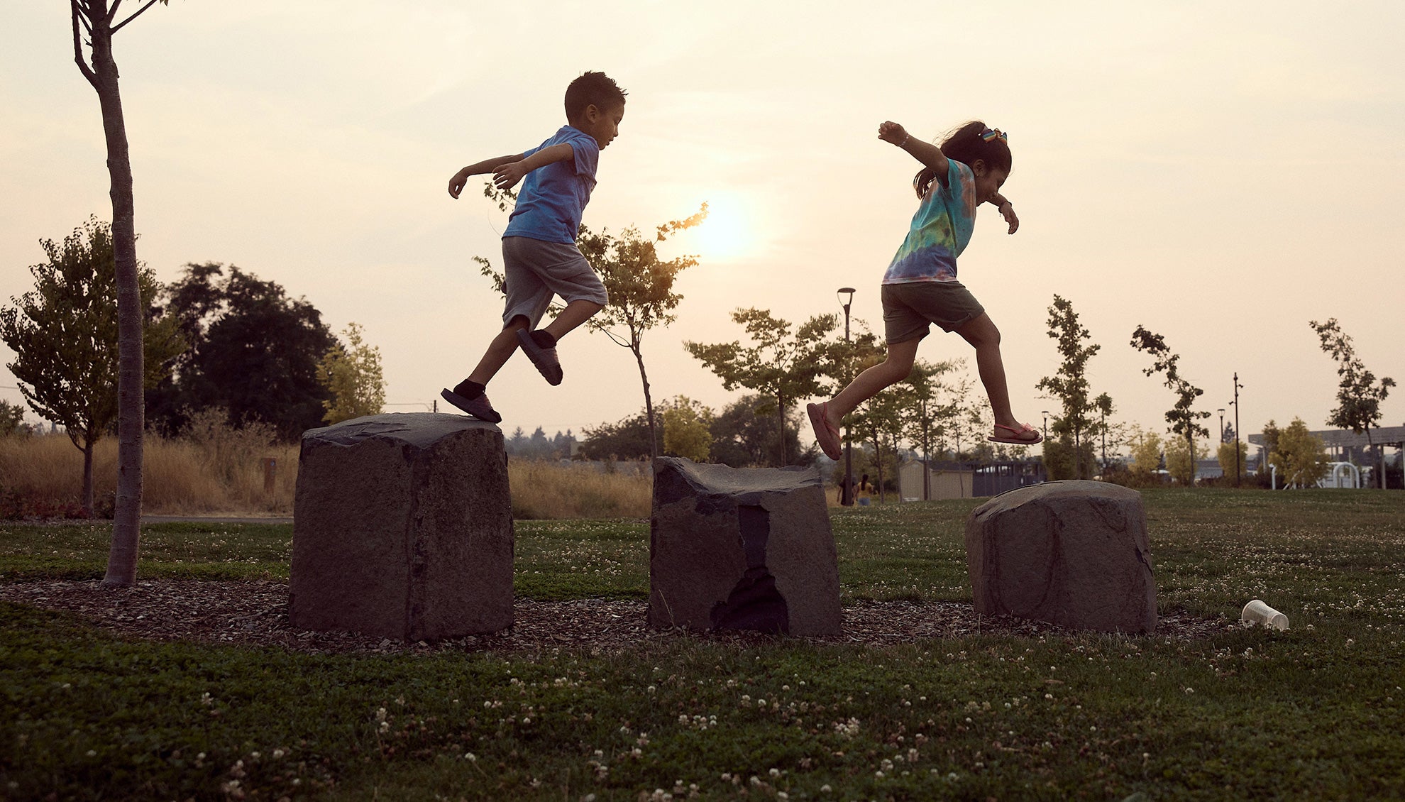 Children play in a park in the Cully neighborhood in Portland, Ore. The community is fighting toxic emissions from an industrial glass facility. Children play in a park in the Cully neighborhood in Portland, Ore. The community is fighting toxic emissions from an industrial glass facility.