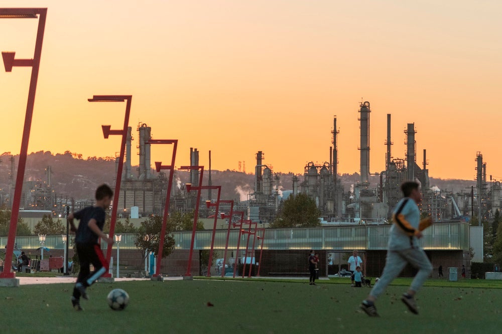 Kids play soccer near the Phillips 66 refinery in Wilmington, Calif.