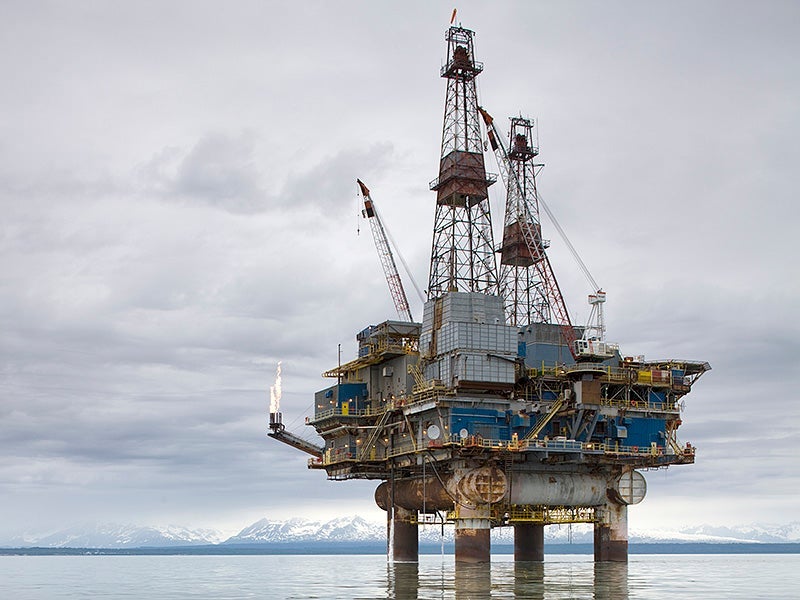 Offshore oil drilling rig in Cook Inlet with distant Alaska Range peaks.
(Paul Souders / Getty Images)